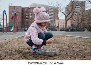 Girl Digging In The Dirt On The Playground On A Foggy Fall Day