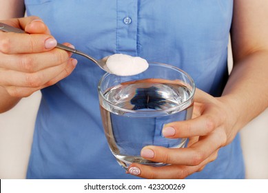 Girl Dilutes The Baking Soda In A Glass Of Water