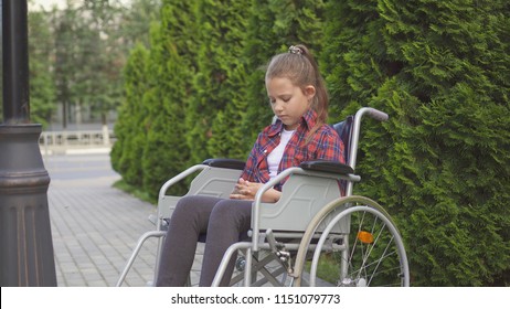 Girl is a disabled person in a wheelchair is sad one