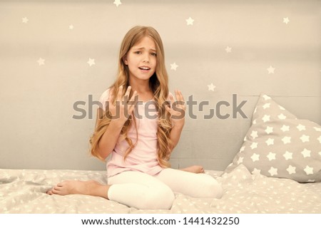 Girl disappointed with long curly hair grey background. Things you shouldnt do at night if you want healthier hair. How to style hair before go to bed. Hair care tips. Easy way keep nice hairstyle.