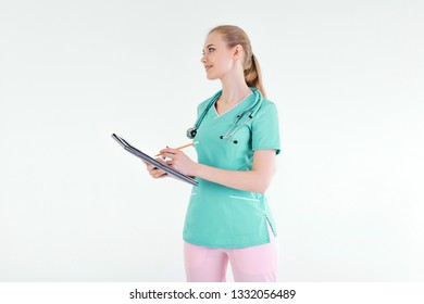 Girl doctor hands pencil folder writes dictates occupation student green uniform practice hospital information.