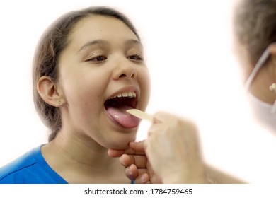 Girl At Doctors Office With Tongue Depressor