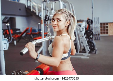 the girl does exercises on simulators