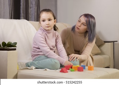 the girl does not respond to the world around us. immersed in thought. Mom turns to the girl. relationship with an autistic child - Powered by Shutterstock