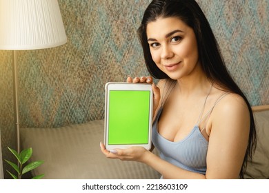 The Girl And Dog Behind The Phone Looks At The Green Screen.