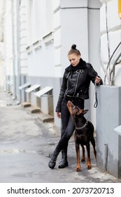 A girl and a dog. A man and a dog are two faithful, beautiful friends. They are happy to see each other, to be together, walking the city streets