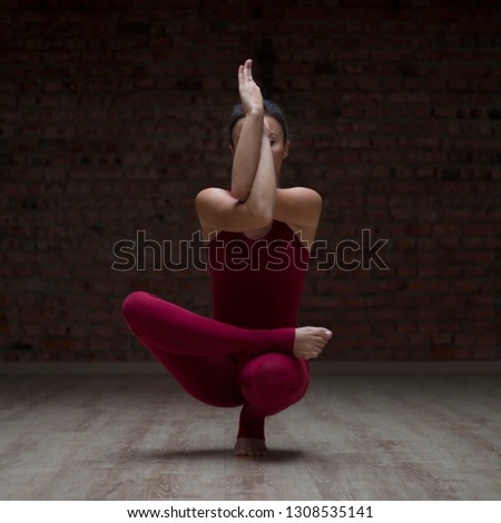 girl doing balance pose in yoga class