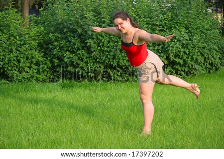 Girl doing exercise on grass