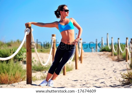 girl doing exercises on the beach