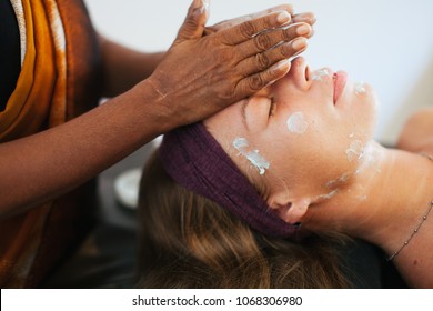 The Girl Doing The Facial Massage . The Cream On The Face. Ayurvedic Treatment. Spa Treatments In Asia. Ayurveda Salon
