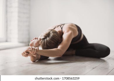 Girl doing fitness exercise, practicing yoga in class, young woman meditating at home. Training, fitness, workout, meditation, yoga, self-care, relaxation, pilates, healthy lifestyle concept - Powered by Shutterstock