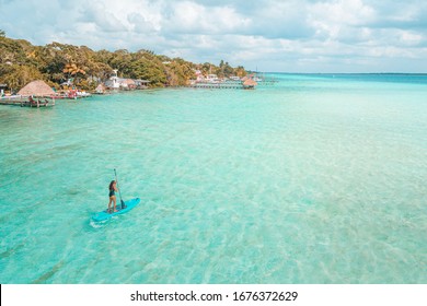 Girl doing paddleboard in Bacalar Lagoon, near Cancun in Riviera Maya, Mexico