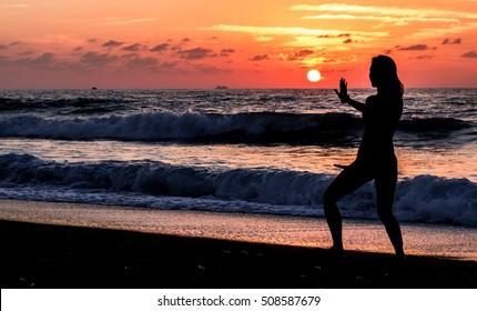 girl doing qigong at sunset on Cyprus