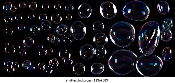 Girl Is Doing Soap Bubble Show On The Black Background