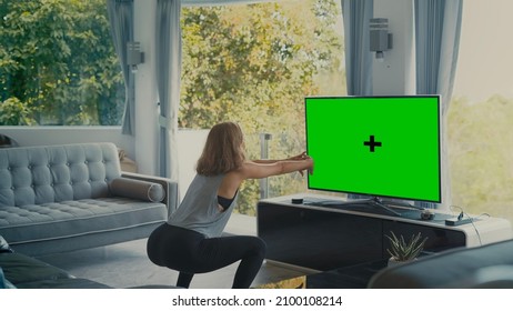 Girl Doing Squad Infront Of Green Screen TV In Living Room