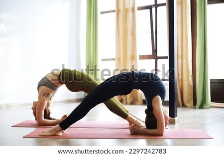 Girl doing yoga exercises in the gym