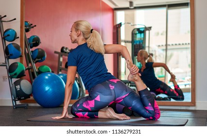 girl doing yoga in the gym - Shutterstock ID 1136279231