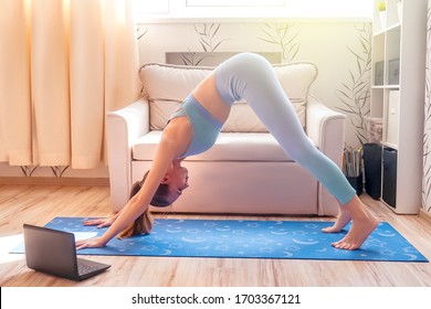 Girl Doing Yoga At Home Online. Watch Tutorial In Laptop.