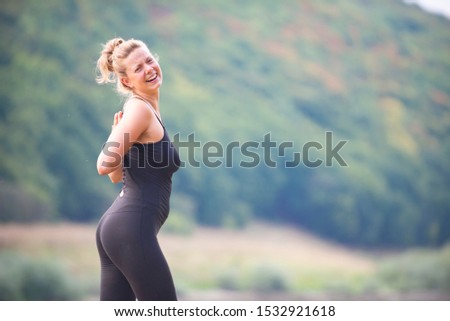 Similar – Woman in sports wear with earphones looking smartphone