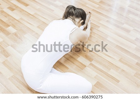 Girl is doing yoga and stretching exercises