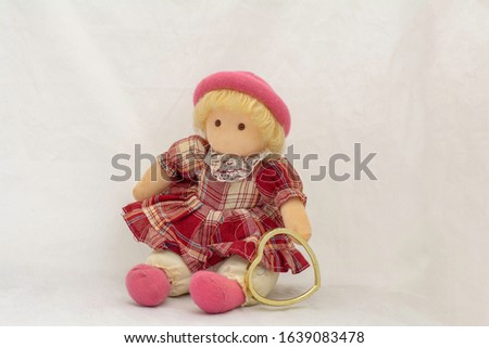 Girl doll and  heart on a white background 