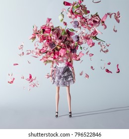 Girl Doll With Pink And Violet Flowers. Creative Minimal Fashion Concept.