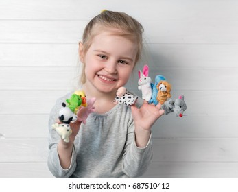 girl with doll puppets on her hands
