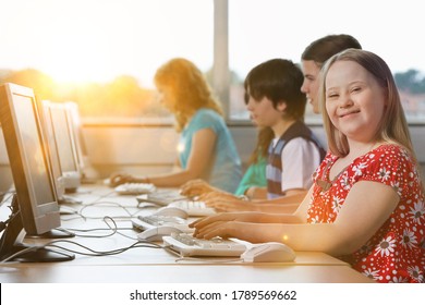 Girl with Down syndrome using computer at school - Shutterstock ID 1789569662