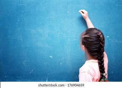 Girl Drawing On Blank Chalkboard