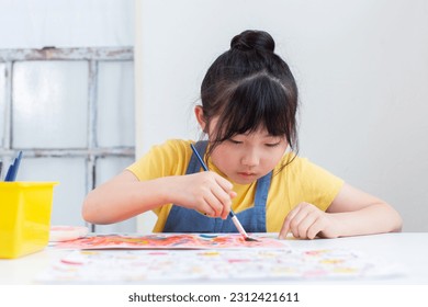 Girl drawing a picture in class