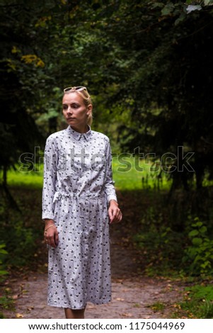 Girl in dress in dark moody forest portrait