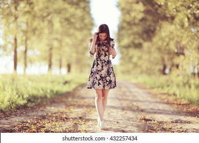 Girl In Dress On The Summer Road