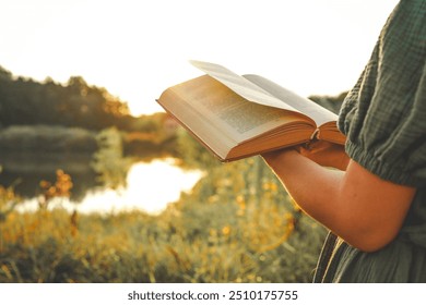 Girl in dress reading book. Sunny morning. - Powered by Shutterstock