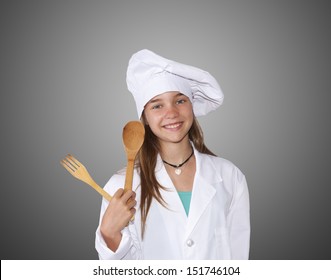 girl dressed in chef with wooden spoon - Powered by Shutterstock