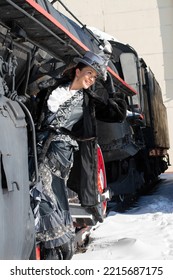 Girl Dressed As A Noblewoman Of The 19th Century Near A Steam Locomotive