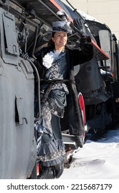 Girl Dressed As A Noblewoman Of The 19th Century Near A Steam Locomotive