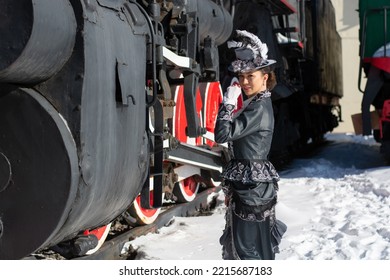 Girl Dressed As A Noblewoman Of The 19th Century Near A Steam Locomotive