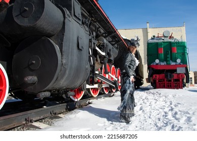 Girl Dressed As A Noblewoman Of The 19th Century Near A Steam Locomotive