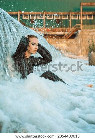 Girl dressed as a pilot in the water summer 2023