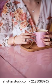 Girl drinking coffee in coffee with cake