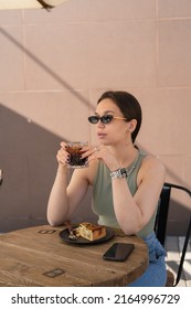 Girl Drinking Cold Coffee On The Street In A сafe