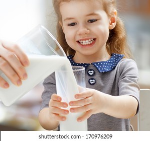 girl drinking milk at the kitchen