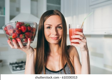 Girl Drinking Strawberry Smoothie On The Kitchen.