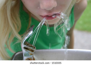 Girl Drinking From A Water Fountain