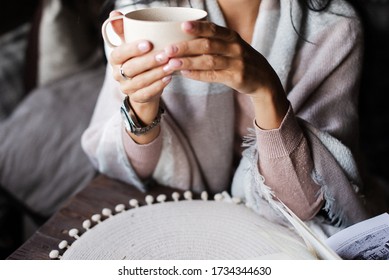 A Girl Drinks Tea In A Wrap. Homemade Tea Drinking. Girl Warms Up With Tea. 