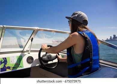 Girl Driving A Boat