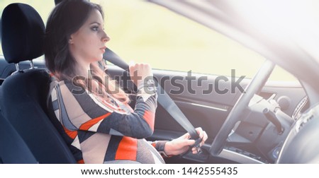 Girl driving a car bad emotions on her face

