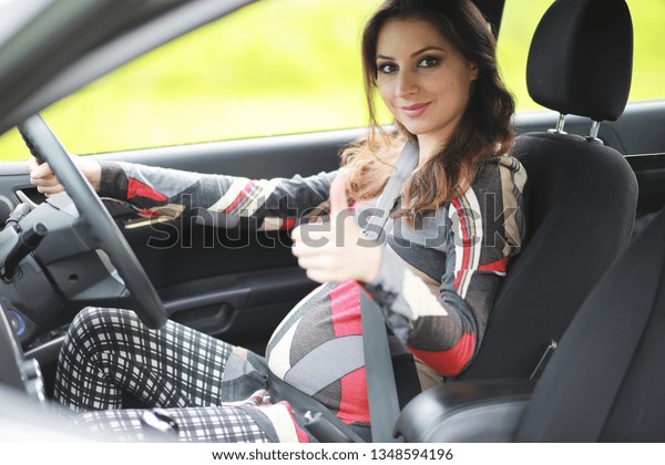 Girl driving a\
car bad emotions on her\
face\
