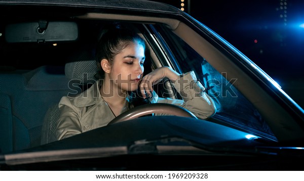 Girl driving car at\
night
