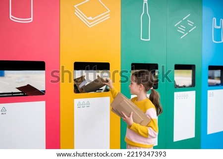 Girl dumping cardboard in bank for reduce, reuse, recycle. National Recycling Day. concept of care for the environment and build sustainable future.